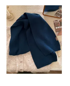 Cozy dark blue pure wool knitted scarf detail showcasing soft texture and warm winter style.
