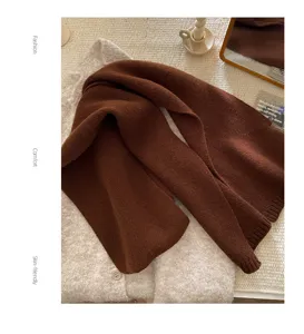 Close-up view of the soft brown knitted winter scarf showing delicate texture and fine ribbed edges.