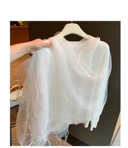 Detailansicht des weißen Stricktops mit zartem Mesh-Schal, elegant und weich für den Alltag.
