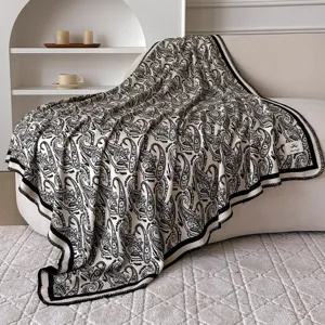 Elegant black and white paisley throw blanket, cozy vintage tassel shawl for home and travel.