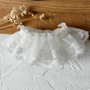 White lace ruffle trim close-up, exquisite mesh fabric detail for Lolita clothing DIY projects.