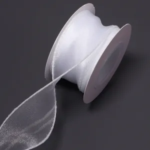 White sheer polyester ribbon spool detail showing translucent texture for gift packaging and DIY.