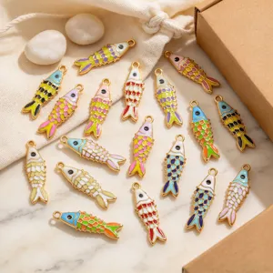 Detailed view of colorful enamel koi fish charms, gold-plated DIY jewelry pendants for necklaces.