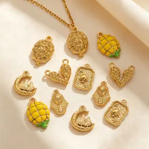 Close-up detail of assorted gold-plated stainless steel embossed charms and pendants for DIY jewelry.