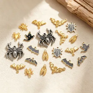 Close-up view of Halloween enamel charms, spiders, bats, and ghosts for DIY jewelry.