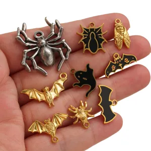 Close-up view of Halloween stainless steel charms featuring spooky spider and bat pendant details.