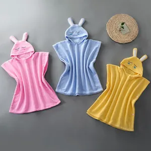 Detailed view of cute kids hooded bunny bath towels in vibrant pink, blue, and yellow colors.