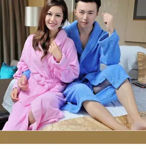 Cozy cotton couple bathrobes in pink and blue, long hotel style design detail view.