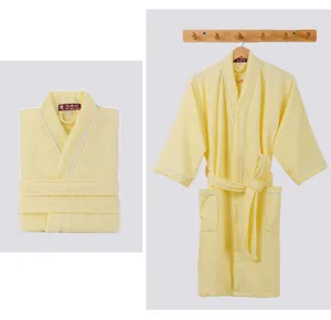 Yellow cotton towel bathrobe detail view showing soft fabric, cozy collar and front pockets.
