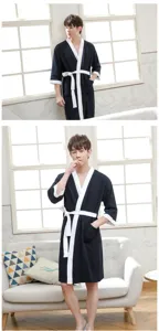 Detail shot of men's waffle cotton bathrobe in dark blue with white trim and belt.