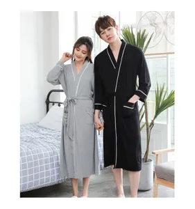 Detail view of couple bamboo fiber bathrobes in grey and black, soft and comfortable home wear.