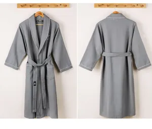 Detail view of the grey waffle cotton bathrobe featuring long sleeves, lapel and waist belt.