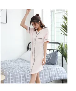 Women short sleeve sleepshirt detail view, pink bamboo lounge dress in bedroom setting.