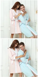 Close-up view of comfortable couple bathrobes in pastel pink and light blue with soft fabric.