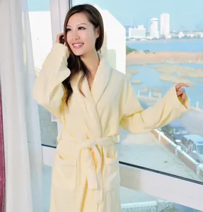 Detailed view of the soft yellow plush bathrobe featuring a comfortable belt and deep pockets.