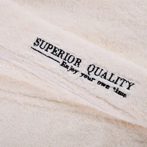 Close up view of premium soft cotton fabric bathrobe towel with delicate embroidery design.