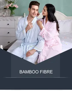Detail view of bamboo fibre couple bathrobes in soft pastel colors, comfortable bedroom scene.