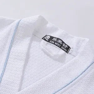 White cotton waffle bathrobe for men and women, hotel sleepwear with blue trim details.