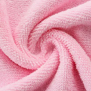Pink cotton towel fabric texture, soft loop material for cozy bathrobes and absorbent bath towels.