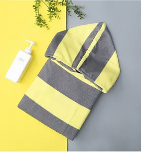 Detailed closeup of a soft yellow and grey striped hooded bath towel made of microfiber.