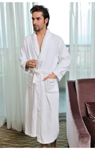 Detailed view of a soft cotton white bathrobe for comfortable hotel and home wear use.