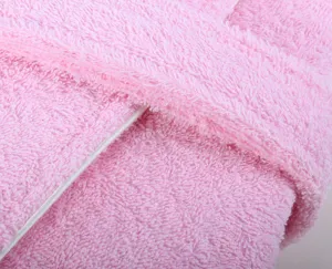 Detailed view of pink cotton bathrobe fabric with soft terry loops and neat white piping edge.