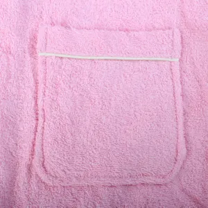 Close-up detail of pink cotton bathrobe pocket with white piping trim showing loop texture.