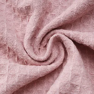 Pink waffle weave bathrobe fabric texture main view, soft hotel sleepwear material close-up.