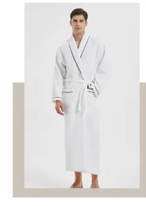 Detailed view of white waffle cotton bathrobe with black piping, showing premium texture.