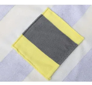 Close-up detail of soft microfiber fabric featuring vibrant yellow and grey striped pattern.