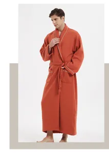 Detailed view of long cotton bathrobe with white piping, cozy loungewear for relaxing moments.