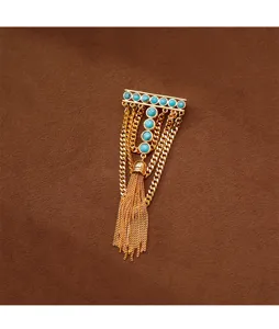 Detailed close-up of turquoise gold tassel brooch showcasing elegant retro design and fine metalwork.