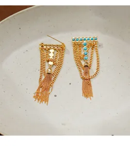 Luxury turquoise long tassel brooch, geometric T-shaped vintage suit accessory detail.