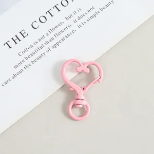 Pink heart shaped snap spring hook metal keychain accessory for DIY crafts and jewelry making.