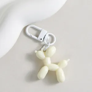 Detailed view of a cute white balloon dog keychain charm, perfect for bags and keys.