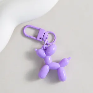Purple balloon dog keychain detail, cute pendant charm for women handbags and DIY crafts.