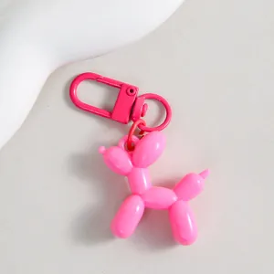 Charming pink balloon dog keychain detail, vibrant resin animal pendant with metal clasp.