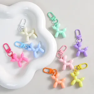 Colorful balloon dog keychain detail, cute resin charm accessory for stylish bags.