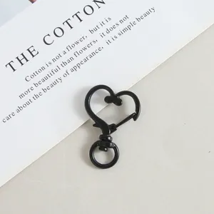 Close-up detail of a black metal heart-shaped lobster clasp, ideal for DIY jewelry making.
