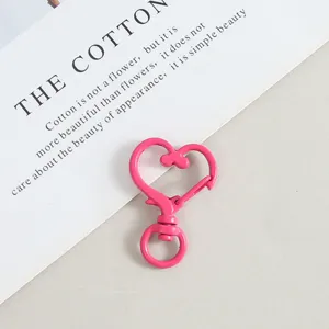 Pink heart snap hook metal keychain DIY jewelry accessory detail shot with smooth finish.