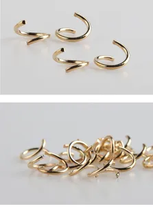 Close-up detail of golden spiral jump rings for DIY jewelry making and connecting accessories.
