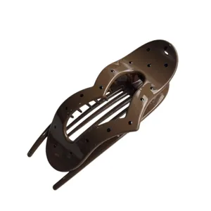 Glossy brown heart shaped hair claw clip detail shot, showing the exquisite polka dot surface.
