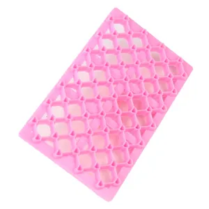 Tapis d'impression en plastique rose motif losange pour fondant pâtisserie, gros plan.