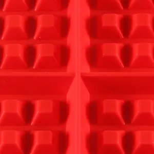 Close-up detail of red silicone waffle baking mold with square grid design for DIY pastry.