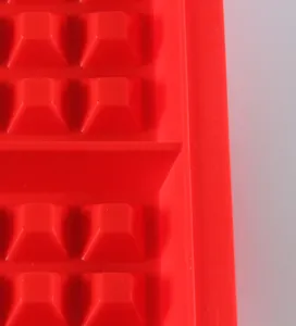 Red silicone baking mold detail closeup showing textured grid structure for DIY pastry making.