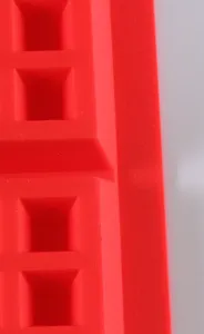 Red silicone baking mold detail view close up waffle chocolate making kitchen tool