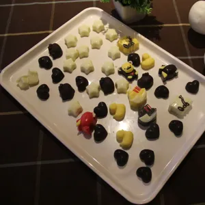 Silicone chocolate mold detail showing various star heart shaped chocolates displayed on a tray.