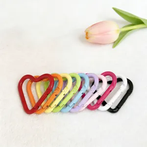 Close-up of colorful heart carabiners, showing vibrant paint finish and detailed hook design.