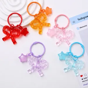 Colorful transparent acrylic bowknot keychains with star pendants, perfect bag charms and gifts.