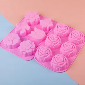 Detailed view of pink silicone flower baking molds, 3D rose and daisy chocolate jelly molds.